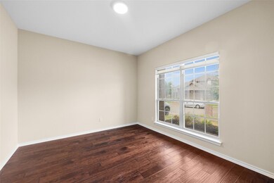 Empty room featuring hardwood / wood-style floorin
