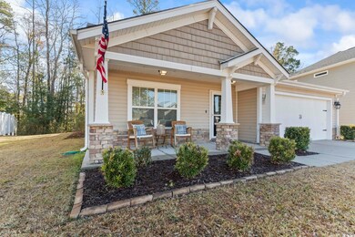 Craftsman-style home with a porch, a garage, and a