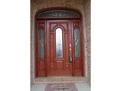 Exterior Front. Elegant front door with transom, s