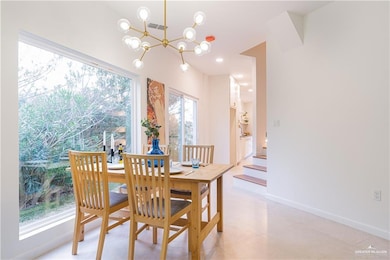 Dining area featuring a chandelier and stairway