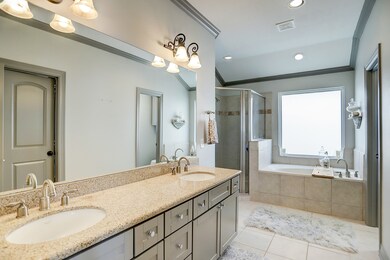 The primary bathroom includes two sinks, a soaker