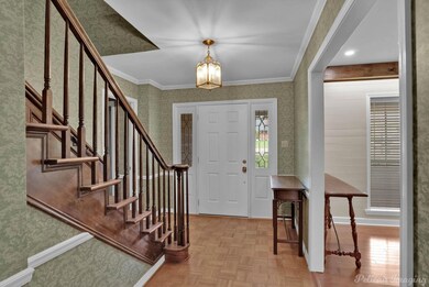 Entryway with a notable chandelier, ornamental mol