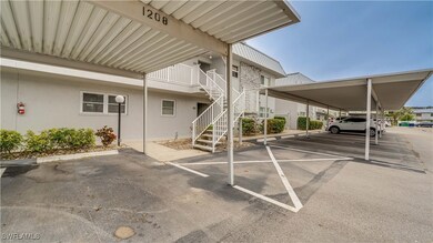 View of parking / parking lot with a carport
