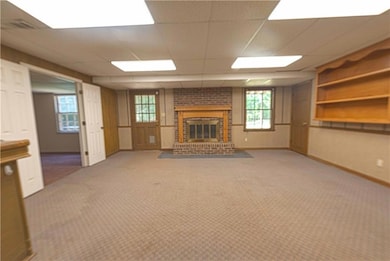 The basement level family room features light carpet, and fireplace