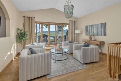 The Foyer Opens to a Lovely Sitting Room with a Beautiful Chandelier and a View of the Pool Area and Surrounding Foothills!