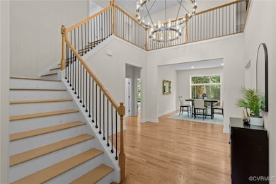 Staircase featuring wood finished floors, a high c