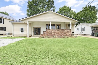 View of front facade with a front yard and brick siding