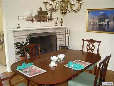 Cozy formal dining room complete with fireplace and hardwood floors.