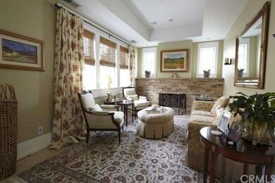 Formal living room with stone fireplace, raised ce