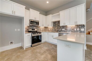Kitchen with stainless steel appliances, a sink, 