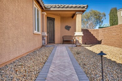 Property entrance featuring stucco siding and fenc