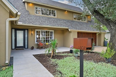 Property entrance featuring a shingled roof, stuc