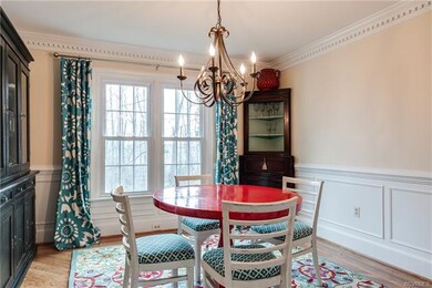The formal dining room has hardwood flooring and d
