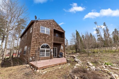 Rear view of property with a balcony and a deck
