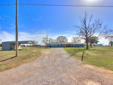 View of front of house featuring dirt driveway, fe