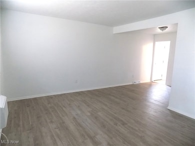 living room with LVT finished floors and baseboards