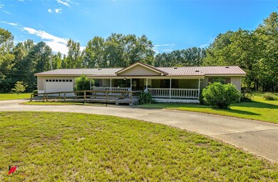 Single story home with a garage and a front yard