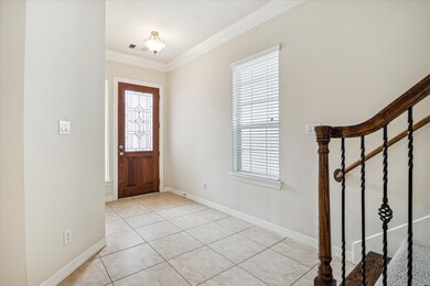 Step into a warm and inviting foyer adorned with g