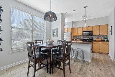 Dining room with light wood finished floors and h