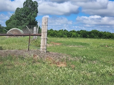 View of green lawn featuring a view of rural / pas