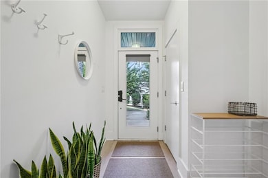 Entrance foyer with glass door and coat closet