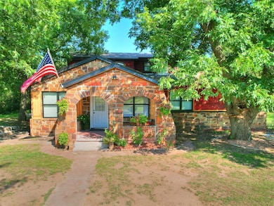 View of front of property with stone siding and covered porch