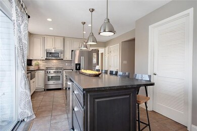 The kitchen features pendant lighting and recessed