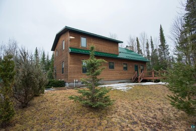 Rear view of property with a deck, a chimney, meta