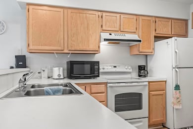 Kitchen featuring light countertops, white applian
