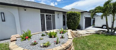 View of exterior entry with stucco siding, roof wi
