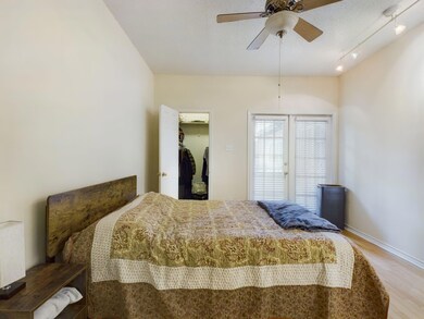 Bedroom with baseboards, wood finished floors, ce