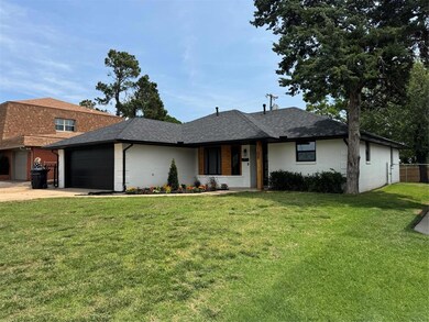 View of front facade with driveway, a garage, brick siding, and roof with shingles