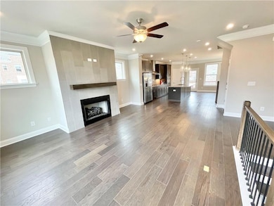 Unfurnished living room with a ceiling fan, orname
