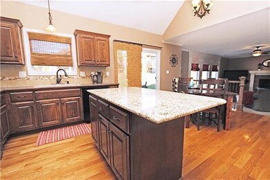 Kitchen island has granite counter top.