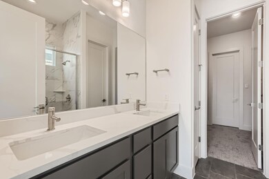 Full bathroom featuring a marble finish shower, d