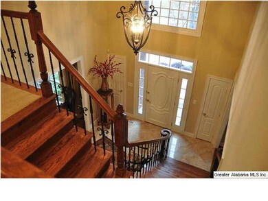 Welcoming entry with tile floor and elegant lighti