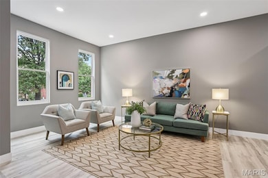 Living room featuring recessed lighting and light wood-style flooring