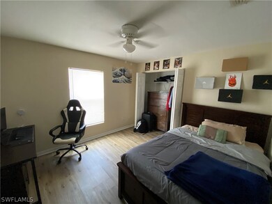 Bedroom #1 with ceiling fan, wood floor and lots of natural light.