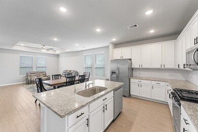 Kitchen has granite counters, island with undermou