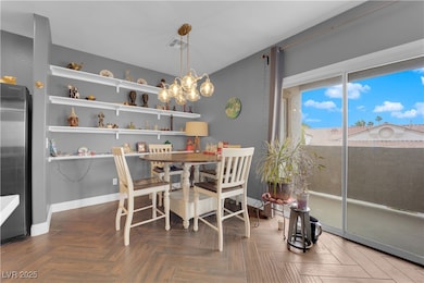 Dining room featuring baseboards and a chandelier