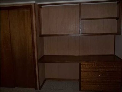 Office in Basement with Closet and Built in Desk.