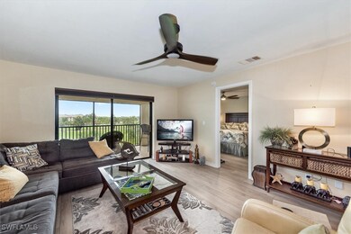 Living room featuring a ceiling fan, light wood-st