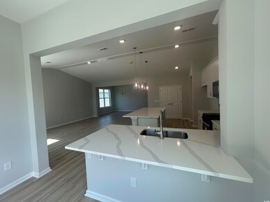 Kitchen featuring a sink, range with gas stovetop, black microwave, baseboards, and light wood-style floors