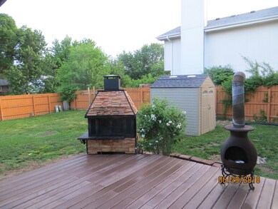 fenced back yard with covered deck