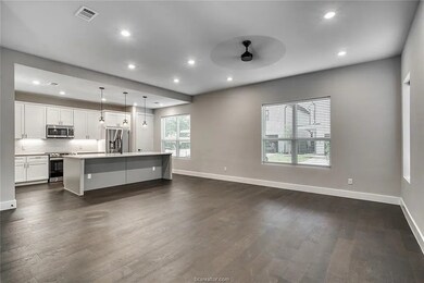 Kitchen featuring stainless steel appliances, dark