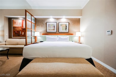 Bedroom with ornamental molding, baseboards, and t