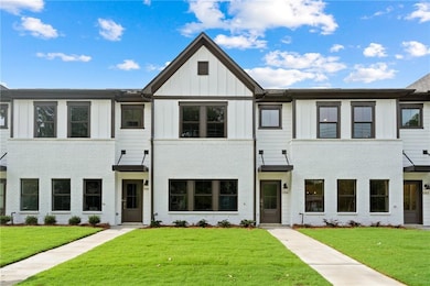 View of front facade featuring a front lawn, board