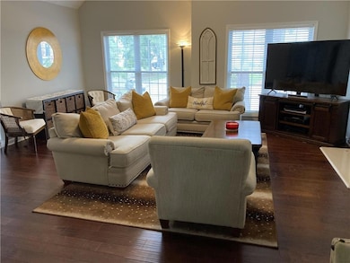 Living room with wood finished floors and healthy amount of natural light