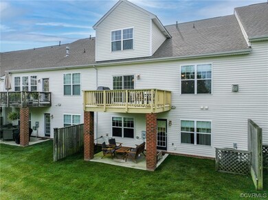 Rear view of house featuring a patio and a lawn (c