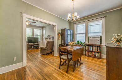 Dining space with ceiling fan with notable chandel